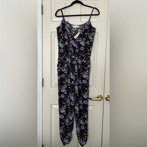 Kittenish black and floral spaghetti strap jumpsuit with pockets.